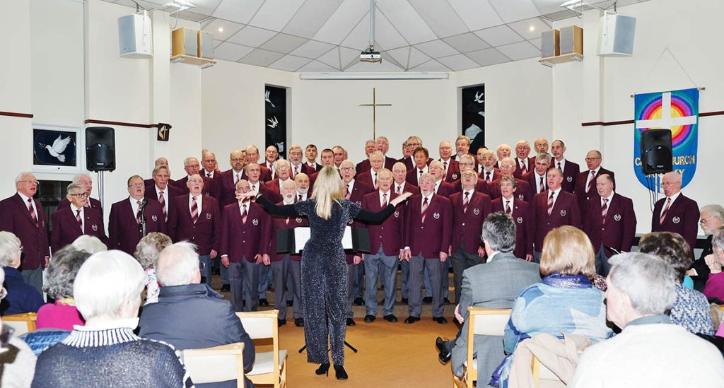 choir singing with lady conductor